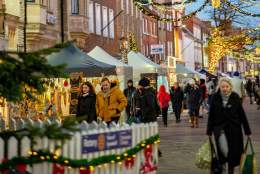 A view of Chichester city centre with Christmas lights and decorations and market stalls