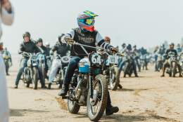 motorbikes gathered on the beach at race the waves