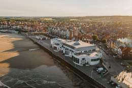 An exterior drone shot of Bridlington south beach, The Spa and town.