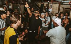J.Mill performing from the floor at Stubb's music venue surrounded by fans.