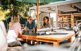 Group of people relaxing at a table at a pub