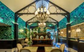 Hulbert House lounge with palm tree decor