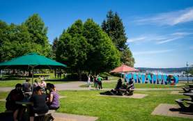 People sitting outside by the Nanaimo sign.