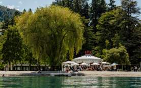 View from the lake looking back at a white cafe shaped like a crown - the Bathhouse Restaurant, a
