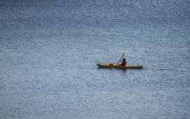 A person kayaking in the ocean