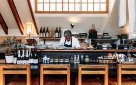 Chef working behind food station at Kappa Japanese restaurant surrounded by quirky Japanese serve wear