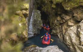 Group of people on inflatable Funyaks going into a chasm
