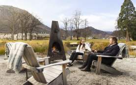 People enjoying at mulled wine by an outdoor fire at Smithy's Smoke House, Millbrook Resort