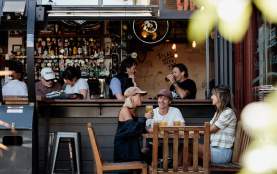 Friends enjoying a pint of beer at Atlas Beer Cafe in Queenstown