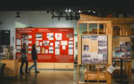 Two people walking through a museum.