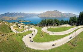 People on the Skyline Queenstown luge with elevated views of Queenstown
