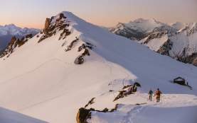 People snowshowing on a snow covered mountain