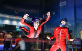 Lady flying next to instructor at iFly