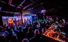 Crowd in front of technicolor lit stage at Empire Control Room.