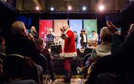 musician Shinyribs in Santa suit at Armadillo Christmas Bazaar in austin texas