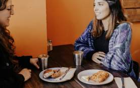 Two people enjoying coffee and scones at Hustl. Café.