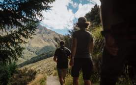 People walking on a nature track with mountains in the distance