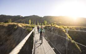 Biking across the Edgar Bridge on the Arrow River Bridges Trail