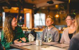 A group of people talking at a table.