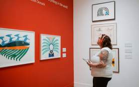 A person viewing different piece of art at the Nanaimo Art Gallery.