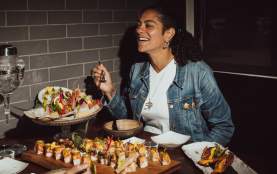 A women enjoying her food at a restaurant.