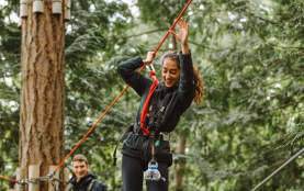 Two people on a tightrope at wildplay.