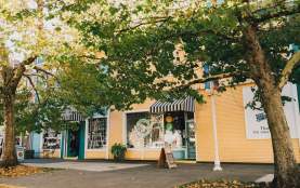 The outside of a row of little shops.