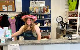 A worker at the counter of the Helping Hospice.