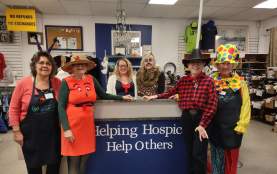 The staff of the Nanaimo Hospice Shoppe in fun clothing posing for the photo.