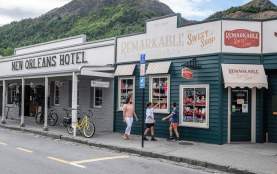 Mother and children walking past the Remarkable Sweet Shop store in Arrowtown
