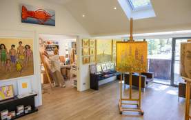 Artist studio with artist painting in the background