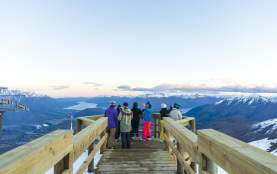 Group of people sightseeing at viewpoint atop of a mountain