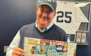Brian Baumgartner (aka Kevin from The Office tv show) holding The Office Self-Guided Tour map