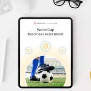 The World Cup Readiness Assessment open on a tablet on a table next to glasses and coffee.