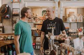 Two men speaking in a shop