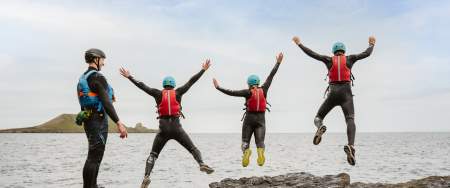 4 people jumping into the sea