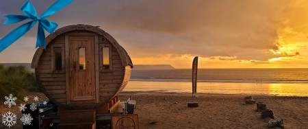 A round sauna shed on a beach.