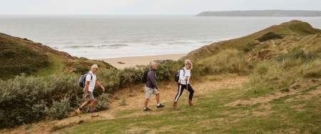3 walkers in sand dunes