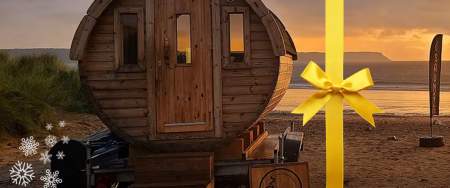 A round sauna shed on a beach.