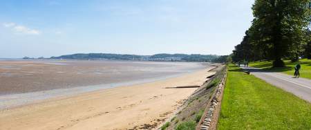 Swansea Bay with a grassy area and path running alongside it.