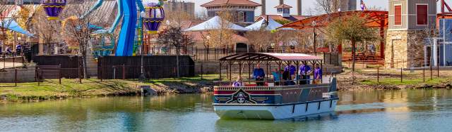 Ferris Wheel and boat overlooking water