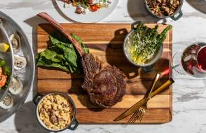 Overhead shot of meat and vegetables on a cutting board at Le Moyne's Chophouse in Mobile, AL things to eat