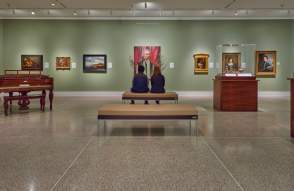 Couple sitting on bench in UMMA looking at painting