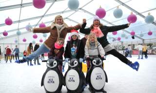 A family dressed up, ice skating at Cheltenham Ice Rink.