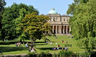 People enjoying the sunshine at Pittville Park Cheltenham in the summer.