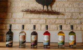 A line of Cotswold Distillery bottles of whisky