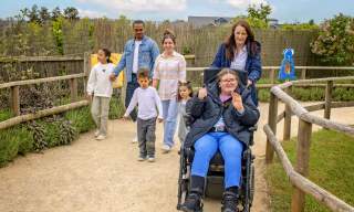 Motorised wheelchair user with family at Fairytale Farm