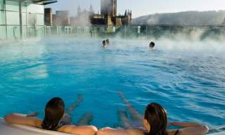 People relaxing in the thermal rooftop pool at thermae Bath Spa