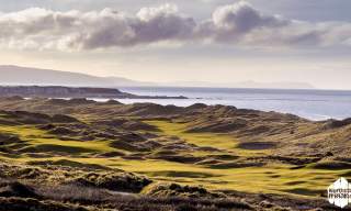 Aerial of the greens and fairways at Royal Portrush Golf Course overlooking the sea