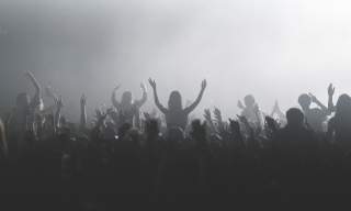 Black and white photograph of a crowd of people watching and enjoying live music